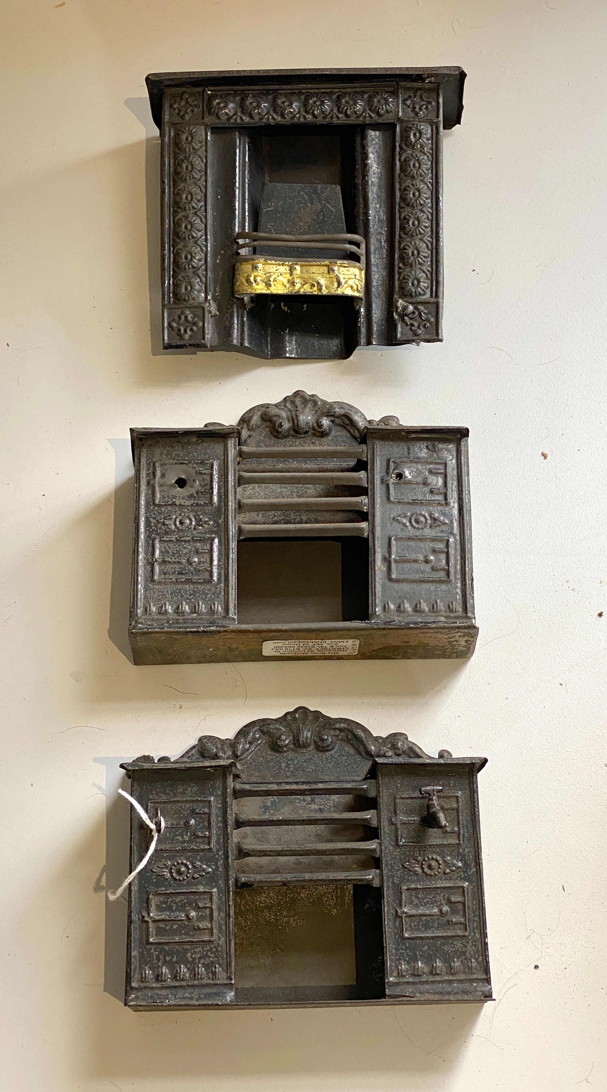 Evans & Cartwright: Two kitchen ranges and a large scale fireplace, the ranges with typical scrolled backs, the fireplace with a border of florets and a gilded grate (3)